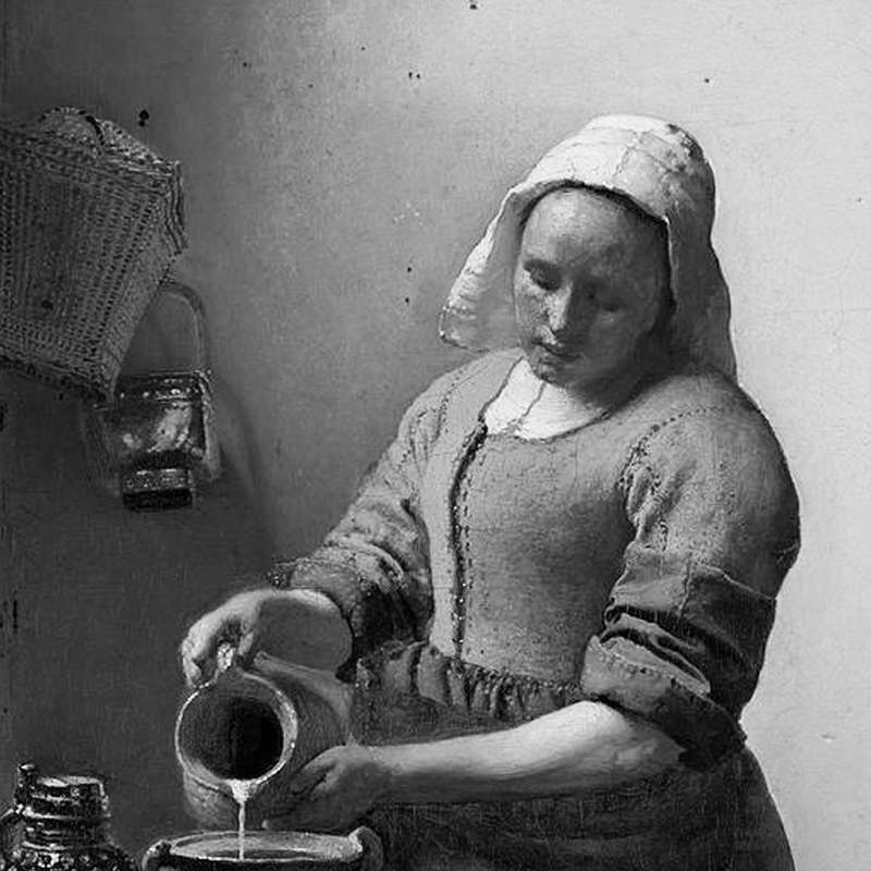 A woman pouring milk into a bowl