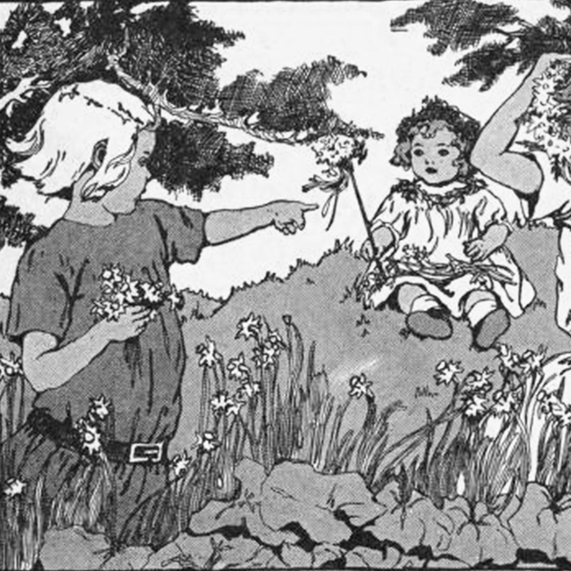 Children outside in a field; one girl holding flowers is pointing at a baby sitting down holding a flower
